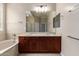 Bright bathroom features soaking tub, double sink vanity and large mirror at 8367 W Lariat Ln, Peoria, AZ 85383