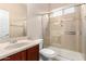 Bathroom featuring a single sink vanity and walk-in shower with glass door at 8367 W Lariat Ln, Peoria, AZ 85383