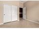 Bedroom features neutral walls, tile flooring, a closet and an adjacent room at 8367 W Lariat Ln, Peoria, AZ 85383