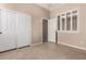Cozy bedroom featuring neutral walls, tile flooring, and a double door closet at 8367 W Lariat Ln, Peoria, AZ 85383