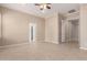 Spacious bedroom featuring neutral walls, tile flooring, ceiling fan and two entryways at 8367 W Lariat Ln, Peoria, AZ 85383