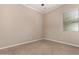 Cozy bedroom featuring neutral walls, tile flooring, and a bright window at 8367 W Lariat Ln, Peoria, AZ 85383