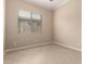 Cozy bedroom featuring neutral walls, tile flooring, and a bright window at 8367 W Lariat Ln, Peoria, AZ 85383