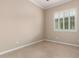Neutral bedroom features tile flooring and bright window with shutter in this cozy home at 8367 W Lariat Ln, Peoria, AZ 85383