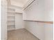 Spacious walk-in closet with built-in shelves and hanging rods at 8367 W Lariat Ln, Peoria, AZ 85383