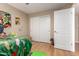 This bedroom features hard wood floors, a window with blinds and a closet at 8861 E Sutton Dr, Scottsdale, AZ 85260
