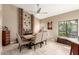 Dining room with a brick fireplace and large window at 8861 E Sutton Dr, Scottsdale, AZ 85260