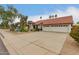 Inviting single-story home showcasing a spacious driveway and three-car garage at 8861 E Sutton Dr, Scottsdale, AZ 85260