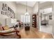 Charming living room featuring a piano, hardwood floors, and large windows with plantation shutters at 8861 E Sutton Dr, Scottsdale, AZ 85260