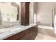 Elegant main bathroom with dual sinks, granite countertops, soaking tub, and plenty of cabinet space at 8861 E Sutton Dr, Scottsdale, AZ 85260