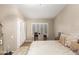 Comfortable main bedroom featuring a desk, plantation shutters, and hardwood floors at 8861 E Sutton Dr, Scottsdale, AZ 85260