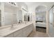Elegant bathroom with dual sinks, large mirrors, and a separate shower area at 9608 E Nacoma Dr, Sun Lakes, AZ 85248