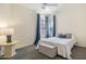 This bedroom features cozy decor, carpeted floors, and bright natural light from the windows at 9608 E Nacoma Dr, Sun Lakes, AZ 85248