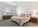 Bright main bedroom with neutral color scheme, large window, and contemporary furniture at 9608 E Nacoma Dr, Sun Lakes, AZ 85248