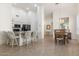 Inviting dining area with elegant chandelier, wood table, and views of the kitchen at 9608 E Nacoma Dr, Sun Lakes, AZ 85248