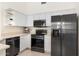 Modern kitchen featuring stainless steel appliances, ample storage, and sleek countertops at 9608 E Nacoma Dr, Sun Lakes, AZ 85248
