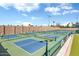 Outdoor pickleball courts with green and blue surfaces, surrounded by greenery and fencing at 9608 E Nacoma Dr, Sun Lakes, AZ 85248
