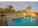 Inviting backyard featuring a refreshing pool and view of the home with desert landscaping in the background at 9834 N 1St St, Phoenix, AZ 85020