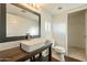Well-lit bathroom with a dark vanity, white sink and fixtures at 9834 N 1St St, Phoenix, AZ 85020