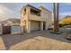 Two-story modern home with desert landscaping, balcony, tall windows, and accent lighting creating an inviting curb appeal at 9834 N 1St St, Phoenix, AZ 85020