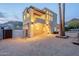 Modern two-story home showcasing a balcony, tall windows, desert landscaping, and stylish architectural lighting at 9834 N 1St St, Phoenix, AZ 85020