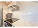 Kitchen featuring stainless steel appliances, quartz countertops and white subway tile backsplash at 9834 N 1St St, Phoenix, AZ 85020