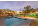 Backyard oasis featuring a modern pool with desert landscaping, a custom mural, and privacy wall at 9834 N 1St St, Phoenix, AZ 85020