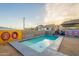 A backyard featuring a sparkling pool surrounded by artistic murals on the privacy wall at 9834 N 1St St, Phoenix, AZ 85020