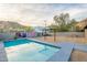 Large backyard with sparkling pool, shaded pergola, and unique, modern art on the privacy walls at 9834 N 1St St, Phoenix, AZ 85020