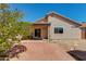 Backyard featuring a red brick patio and beige stucco exterior wall at 995 E Vernoa St, San Tan Valley, AZ 85140