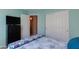 Bedroom showcasing aqua walls, slider closet and TV console at 995 E Vernoa St, San Tan Valley, AZ 85140