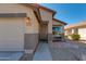 Home exterior showing the front door, landscaped yard and attached two car garage at 995 E Vernoa St, San Tan Valley, AZ 85140