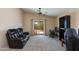 Comfortable living room with access to backyard and featuring a work space and lounge area at 995 E Vernoa St, San Tan Valley, AZ 85140
