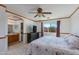 Bright main bedroom with ceiling fan, TV, and ensuite bathroom access at 995 E Vernoa St, San Tan Valley, AZ 85140