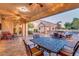Spacious backyard features a patio, outdoor bar, and serene water feature at 10059 W Villa Lindo Dr, Peoria, AZ 85383