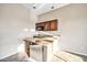 An airy bar area is equipped with a granite countertop, cabinets, and a microwave at 10059 W Villa Lindo Dr, Peoria, AZ 85383