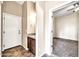 Well-lit bathroom with granite countertop, wood cabinets, and tiled flooring at 10059 W Villa Lindo Dr, Peoria, AZ 85383
