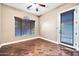 Bedroom with ceiling fan, wood floors, and a sliding door to the exterior at 10059 W Villa Lindo Dr, Peoria, AZ 85383