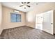 Comfortable bedroom with neutral carpet, ceiling fan and a large window at 10059 W Villa Lindo Dr, Peoria, AZ 85383