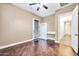 Bedroom with desk, ceiling fan, wood floors, and a doorway to another room at 10059 W Villa Lindo Dr, Peoria, AZ 85383