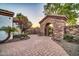 Paver walkway leading to a gated entrance with stone archway and desert landscaping at 10059 W Villa Lindo Dr, Peoria, AZ 85383