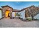 Inviting home entrance with stone accents, a paved walkway, and mature landscaping at 10059 W Villa Lindo Dr, Peoria, AZ 85383