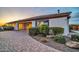 Property featuring a brick driveway, mature landscaping, and stucco exterior at 10059 W Villa Lindo Dr, Peoria, AZ 85383