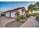 Property featuring a brick driveway, mature landscaping, and multi-car garage at 10059 W Villa Lindo Dr, Peoria, AZ 85383