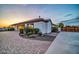 Beautiful stucco house with well-maintained landscaping and a brick driveway leading to a private entrance at 10059 W Villa Lindo Dr, Peoria, AZ 85383