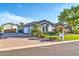 View of the home's exterior and three-car garage with a brick-paved driveway at 10059 W Villa Lindo Dr, Peoria, AZ 85383