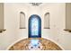 Foyer with decorative tile flooring and a custom arched front door with a glass insert at 10059 W Villa Lindo Dr, Peoria, AZ 85383