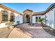 Covered entrance featuring brick pavers and a stone archway at 10059 W Villa Lindo Dr, Peoria, AZ 85383