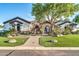 Charming single-story home featuring a stone gatehouse and manicured landscaping at 10059 W Villa Lindo Dr, Peoria, AZ 85383