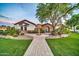 Beautiful exterior with a fountain, arched entrance, lush landscaping, and well-manicured lawn at 10059 W Villa Lindo Dr, Peoria, AZ 85383